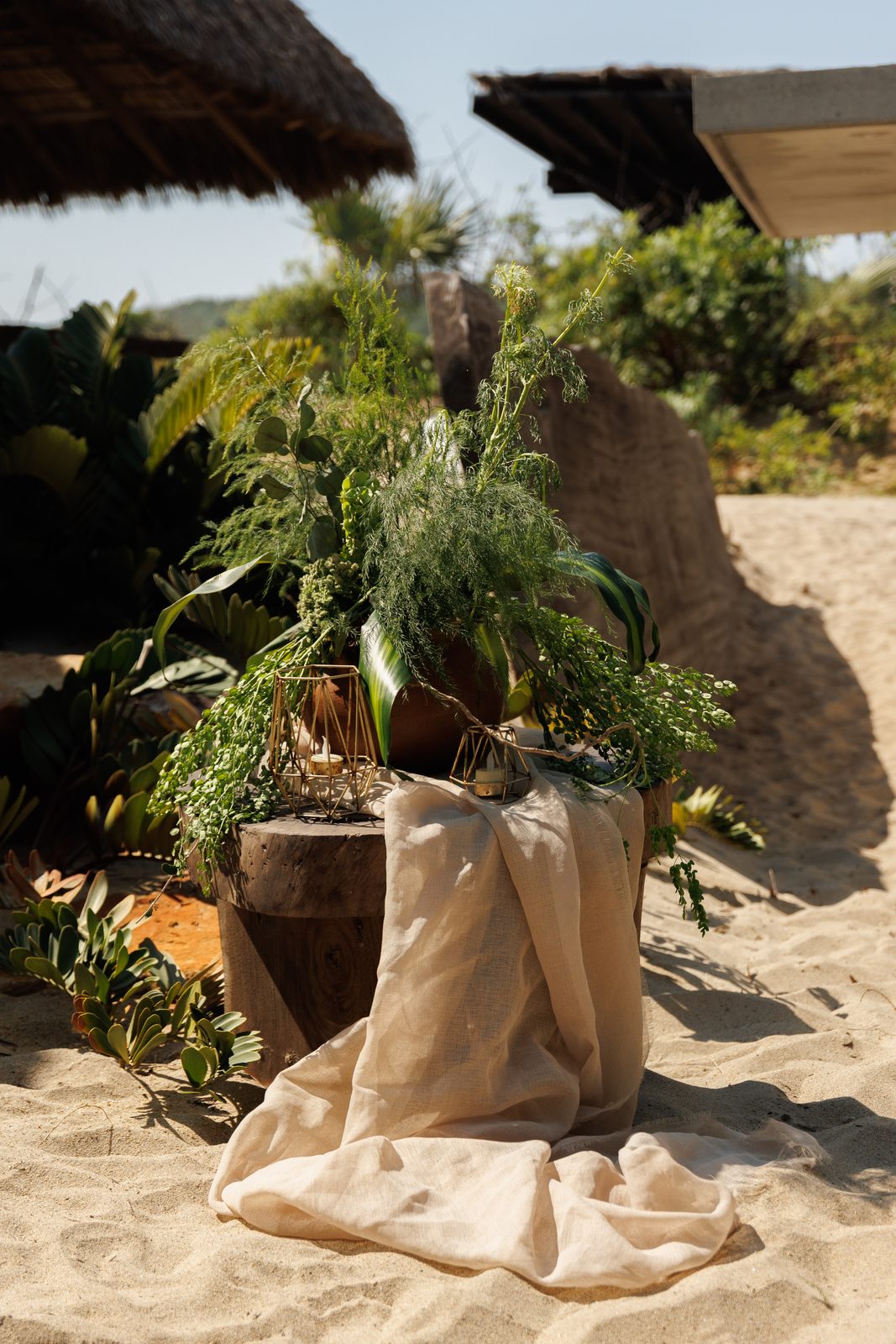 Tropical floral arrangement on sandy beach