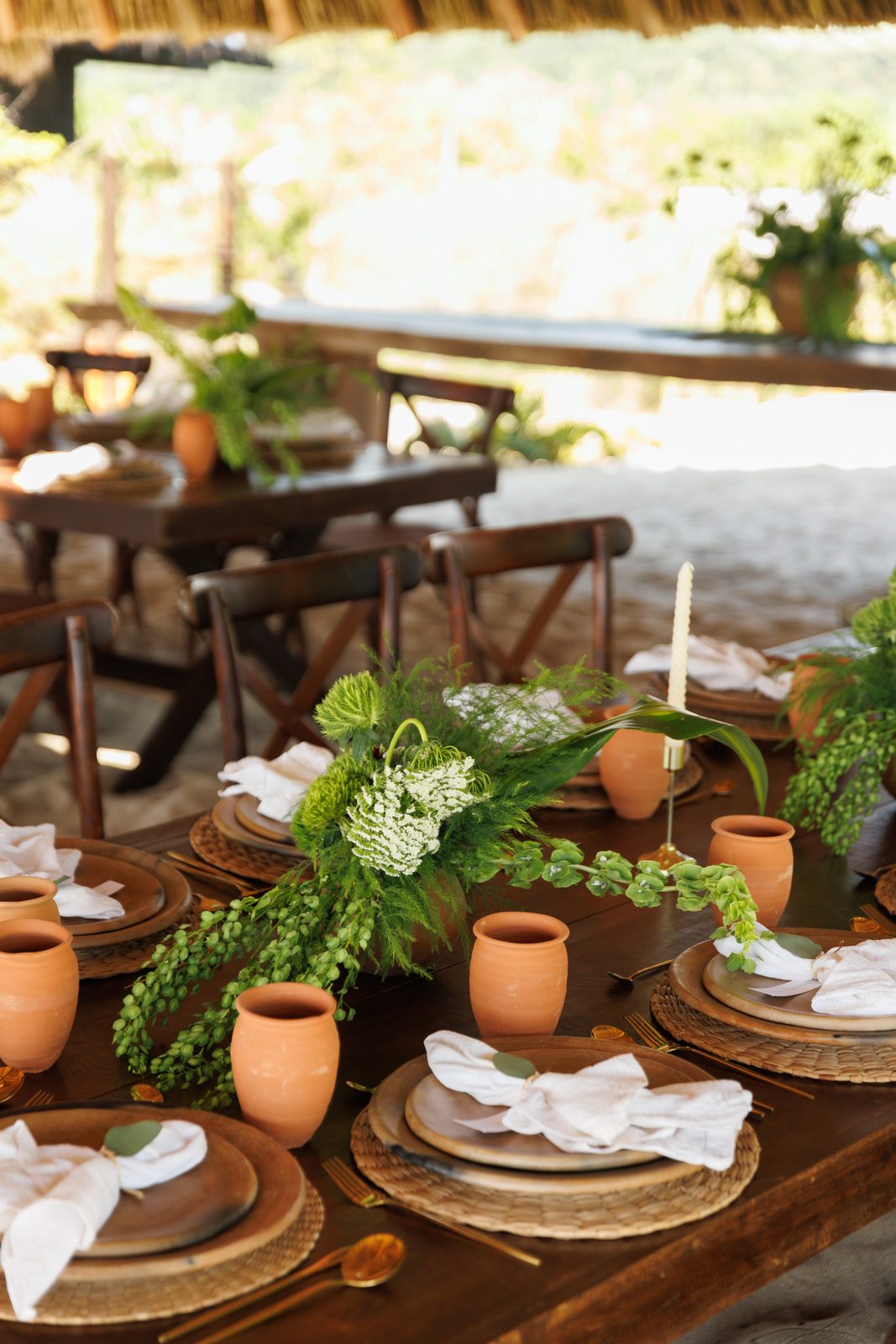 Wide view of reception table with tropical greenery decor