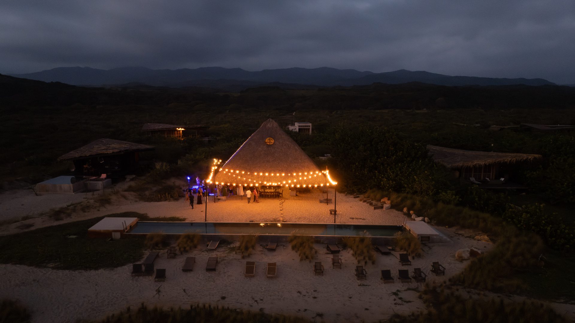 Wide aerial night shot of wedding venue with warm lighting
